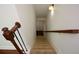 A staircase with carpeted treads and dark wooden railing leads to the lower level of this home at 3692 Lambert Ne Ln, Brookhaven, GA 30319