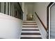 Elegant staircase with dark wood treads, white risers, and iron railing leads upstairs at 3692 Lambert Ne Ln, Brookhaven, GA 30319