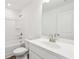 Well-lit bathroom featuring a shower-tub combo and a modern vanity with a neutral color scheme at 5108 Arista Dr, Douglasville, GA 30135
