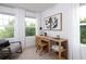 Charming home office filled with natural light, featuring a sleek desk and scenic outdoor views at 5108 Arista Dr, Douglasville, GA 30135