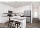 Contemporary kitchen featuring an island with seating, stainless steel appliances, and white cabinetry at 5108 Arista Dr, Douglasville, GA 30135