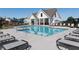 Community pool area is surrounded by lounge chairs for relaxing poolside on a sunny day at 5108 Arista Dr, Douglasville, GA 30135