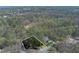 Aerial view of the property surrounded by lush trees, showing the boundaries at 9995 Huntcliff Trce, Atlanta, GA 30350
