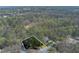 Aerial view showcasing the property's wooded lot and proximity to neighborhood at 9995 Huntcliff Trce, Atlanta, GA 30350