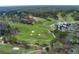 Aerial view of golf course, clubhouse, and surrounding landscape at 9995 Huntcliff Trce, Atlanta, GA 30350