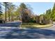 Stone entrance to Cherokee Country Club with manicured landscaping and wrought iron gates at 9995 Huntcliff Trce, Atlanta, GA 30350