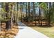 Long driveway leading to the secluded residence surrounded by mature trees at 9995 Huntcliff Trce, Atlanta, GA 30350