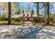 Charming brick home boasts mature trees, manicured lawn, and beautiful brick pathway at 9995 Huntcliff Trce, Atlanta, GA 30350