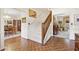 Bright foyer with hardwood flooring, chandelier, staircase and view to dining and living rooms at 9995 Huntcliff Trce, Atlanta, GA 30350
