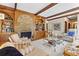 Inviting living room featuring a brick fireplace and wood beamed ceiling at 9995 Huntcliff Trce, Atlanta, GA 30350