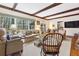 Bright living room with exposed beams, large windows, and comfortable seating at 9995 Huntcliff Trce, Atlanta, GA 30350