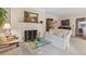 Inviting living room featuring a fireplace, artwork, and plush seating at 9995 Huntcliff Trce, Atlanta, GA 30350