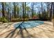 An inviting, covered pool area provides a backyard oasis surrounded by mature trees and greenery at 9995 Huntcliff Trce, Atlanta, GA 30350