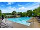 Outdoor swimming pool with adjacent lounge chairs and wooded background at 9995 Huntcliff Trce, Atlanta, GA 30350