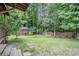 Expansive backyard with lush greenery, a playhouse, and a fire pit, perfect for outdoor enjoyment at 1888 Kelvin Dr, Lawrenceville, GA 30043