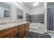Bathroom featuring double sinks, a large tub with decorative tile and shower at 1888 Kelvin Dr, Lawrenceville, GA 30043