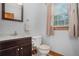 Cozy bathroom with a modern vanity, neutral decor, and natural light streaming through the window at 1888 Kelvin Dr, Lawrenceville, GA 30043