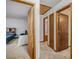 Hallway leading to cozy bedroom, complete with a neutral carpet and door entry at 1888 Kelvin Dr, Lawrenceville, GA 30043