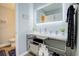 Well-lit bathroom featuring a sleek vanity with open shelving for storage and a modern, illuminated mirror at 24317 Plantation Ne Dr, Atlanta, GA 30324