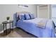 Comfortable bedroom with a bed with blue bedding and a black round bedside table at 24317 Plantation Ne Dr, Atlanta, GA 30324