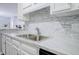 Modern kitchen featuring stainless steel appliances, white cabinets, and a stylish backsplash at 24317 Plantation Ne Dr, Atlanta, GA 30324