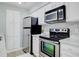 Modern kitchen featuring stainless steel appliances, white cabinets, and ample counter space at 24317 Plantation Ne Dr, Atlanta, GA 30324