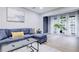 Bright living room with sleek furniture, hardwood floors, and abundant natural light from large windows at 24317 Plantation Ne Dr, Atlanta, GA 30324