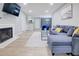 Open-concept living area featuring a fireplace, comfortable seating, and dining space at 24317 Plantation Ne Dr, Atlanta, GA 30324