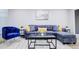 Stylish living room featuring a plush blue sectional sofa, contemporary decor, and ample seating at 24317 Plantation Ne Dr, Atlanta, GA 30324