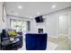 Chic living room boasting a cozy blue couch, fireplace, and a glimpse into a bright hallway at 24317 Plantation Ne Dr, Atlanta, GA 30324