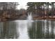 Scenic view of the pond with fountain creating a serene and inviting outdoor space at 24317 Plantation Ne Dr, Atlanta, GA 30324