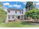 Back exterior featuring a pergola, screened-in porch, and lush greenery at 3517 Ridgemill Cir, Dacula, GA 30019