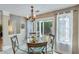 Cozy dining area with sliding doors, elegant chandelier, and neutral decor, perfect for everyday living at 3517 Ridgemill Cir, Dacula, GA 30019