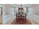 Elegant dining room featuring a chandelier, wainscoting, and a large window at 3517 Ridgemill Cir, Dacula, GA 30019