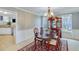 Formal dining room showcasing a wood table, elegant chandelier, and classic china cabinet for refined living at 3517 Ridgemill Cir, Dacula, GA 30019