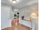 Bright foyer with hardwood floors, a white wainscoting, and a view into the living area at 3517 Ridgemill Cir, Dacula, GA 30019