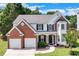 Beautiful two-story home with a brick and siding exterior, a well-maintained lawn, and a two-car garage at 3517 Ridgemill Cir, Dacula, GA 30019