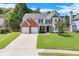 Charming two-story home with a well-manicured lawn and a two-car garage in a lovely suburban neighborhood at 3517 Ridgemill Cir, Dacula, GA 30019