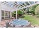 Relaxing hot tub on a wooden deck, surrounded by a lush green lawn and a charming pergola at 3517 Ridgemill Cir, Dacula, GA 30019
