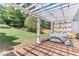 Relaxing hot tub on a wooden deck, surrounded by a lush green lawn and a charming pergola at 3517 Ridgemill Cir, Dacula, GA 30019