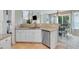 Well-lit kitchen features granite countertops, stainless steel dishwasher, and tiled floors for modern appeal at 3517 Ridgemill Cir, Dacula, GA 30019