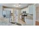 Efficient kitchen features stainless steel appliances, granite counters, and tiled flooring at 3517 Ridgemill Cir, Dacula, GA 30019