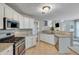 Bright kitchen featuring white cabinets, granite countertops, stainless steel appliances, and tile flooring at 3517 Ridgemill Cir, Dacula, GA 30019