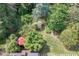 Lush backyard featuring a patio with a red umbrella, surrounded by mature trees and landscaping at 3517 Ridgemill Cir, Dacula, GA 30019
