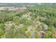 An aerial shot showcases the home nestled amongst lush trees in a quiet, residential neighborhood at 376 Paula Ct, Lawrenceville, GA 30046