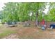 Expansive backyard features a trampoline, outdoor furniture, mature trees, and a wooden fence at 376 Paula Ct, Lawrenceville, GA 30046