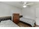 Comfortable bedroom with two beds, wood floors, ceiling fan, and chest of drawers at 376 Paula Ct, Lawrenceville, GA 30046