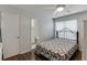 Bedroom with hardwood floors, ceiling fan and adjacent bathroom at 376 Paula Ct, Lawrenceville, GA 30046