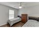 Bedroom featuring twin beds, hardwood floors, ceiling fan, and a chest of drawers at 376 Paula Ct, Lawrenceville, GA 30046