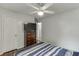 Bedroom with hardwood floors, ceiling fan, and a chest of drawers at 376 Paula Ct, Lawrenceville, GA 30046